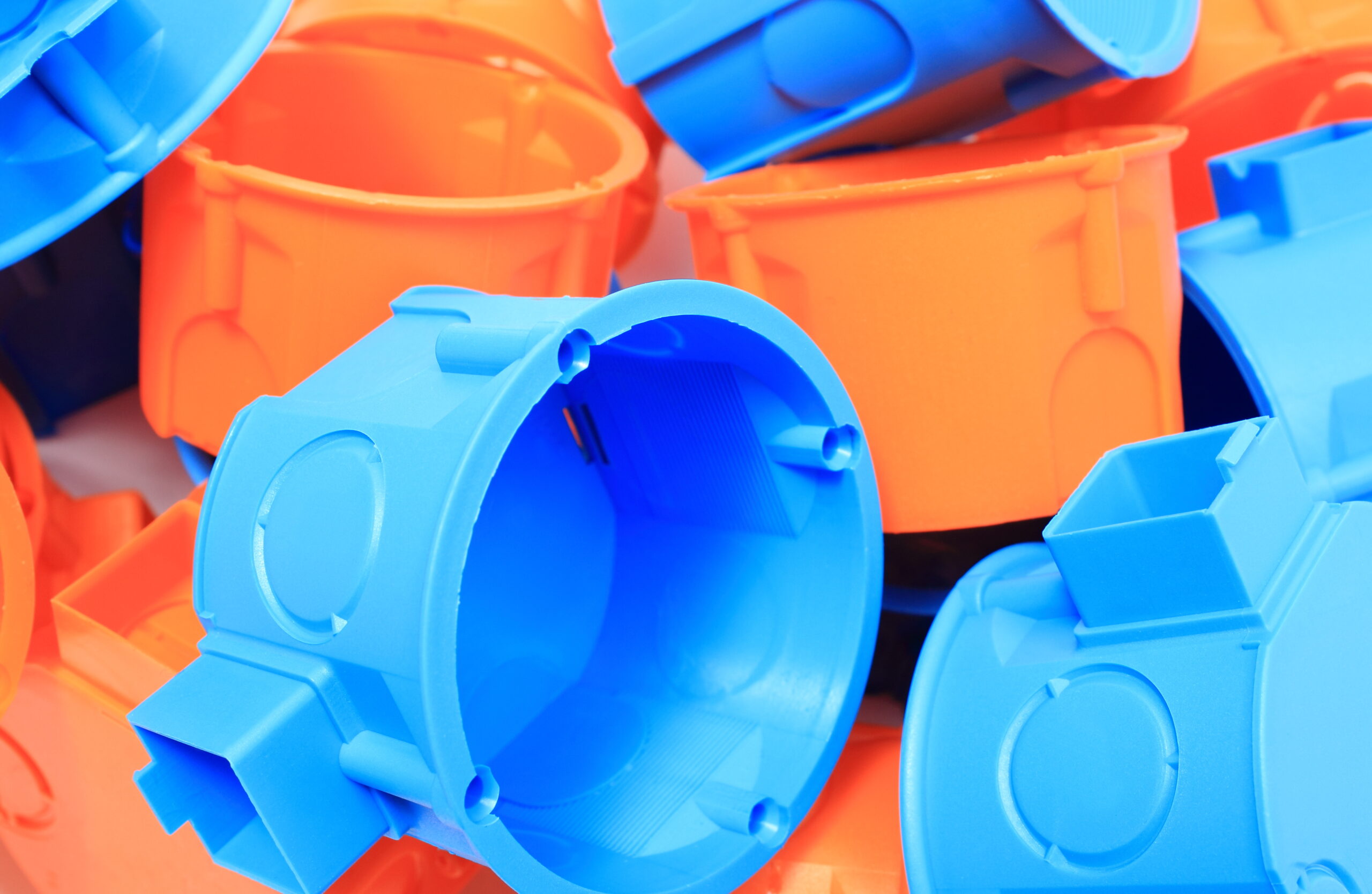 Heap of Orange and Blue Electrical Boxes | Reedy Chemical Foam Close-up of a pile of blue and orange plastic construction toy pieces.
