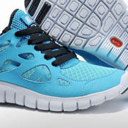 Blue running shoe close-up showing black laces, breathable mesh upper, and white sole detail of the tread pattern.
